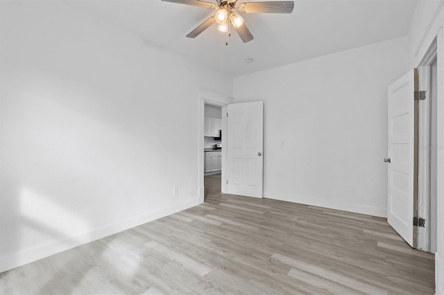 unfurnished bedroom with ceiling fan and light wood-type flooring