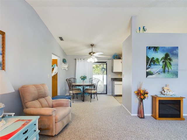 interior space with lofted ceiling, light carpet, and ceiling fan