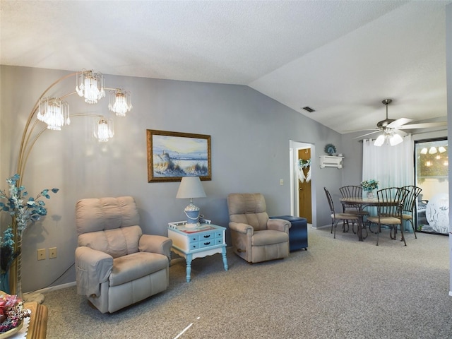 living room featuring vaulted ceiling, carpet floors, and ceiling fan with notable chandelier