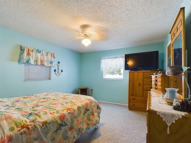 carpeted bedroom with a textured ceiling and ceiling fan