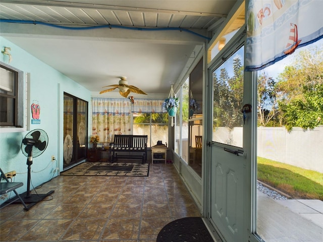 sunroom featuring ceiling fan