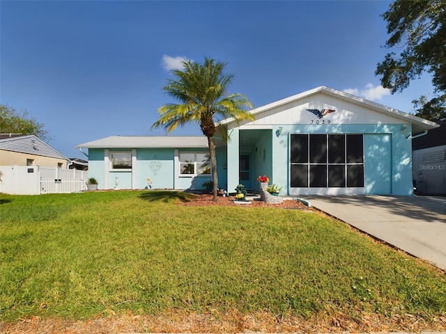 view of front of property with a garage and a front yard