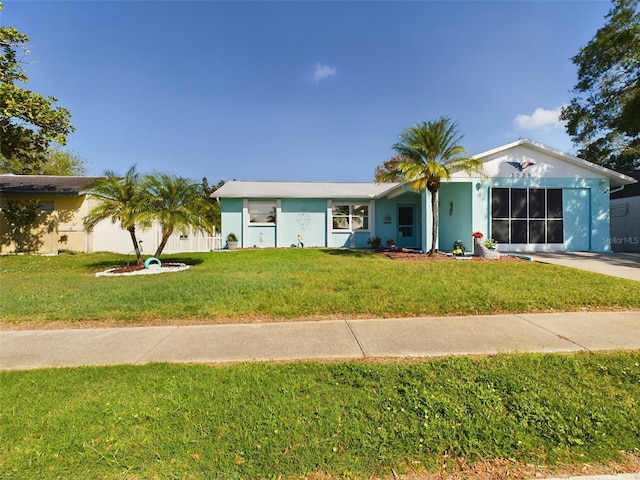 ranch-style home featuring a garage and a front lawn