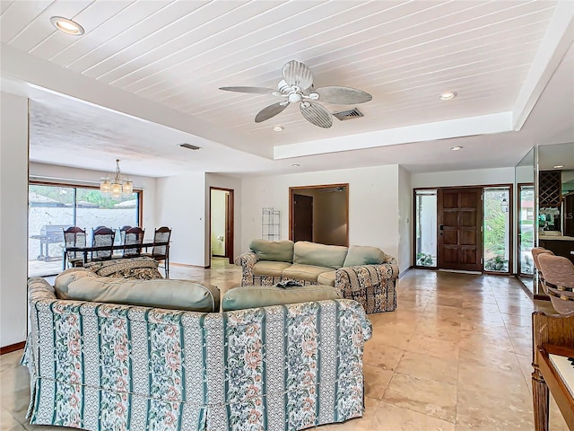 living room featuring light tile patterned floors, ceiling fan with notable chandelier, a tray ceiling, and wooden ceiling