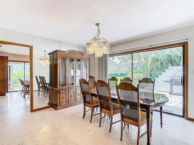 dining area with plenty of natural light and an inviting chandelier