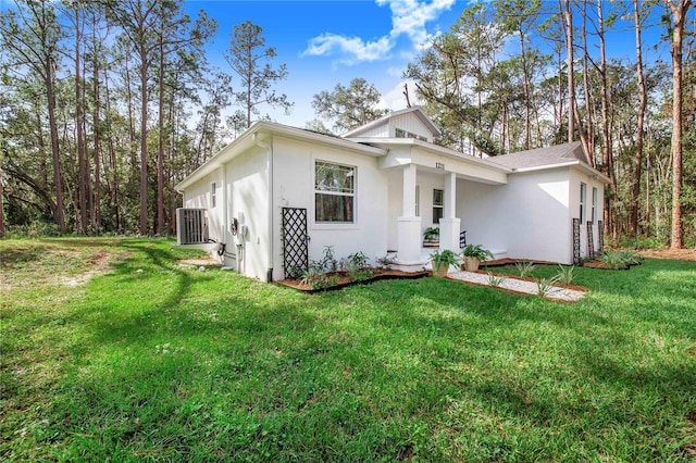 view of front of property with central air condition unit and a front lawn