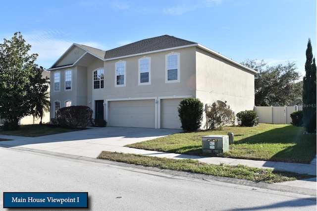 view of front facade featuring concrete driveway, stucco siding, fence, a front yard, and a garage