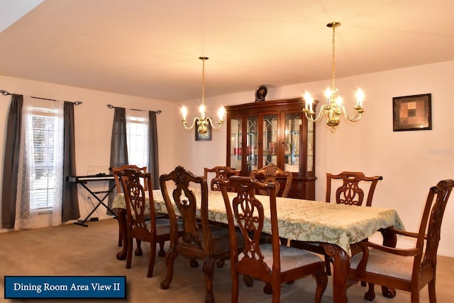 carpeted dining space featuring a chandelier