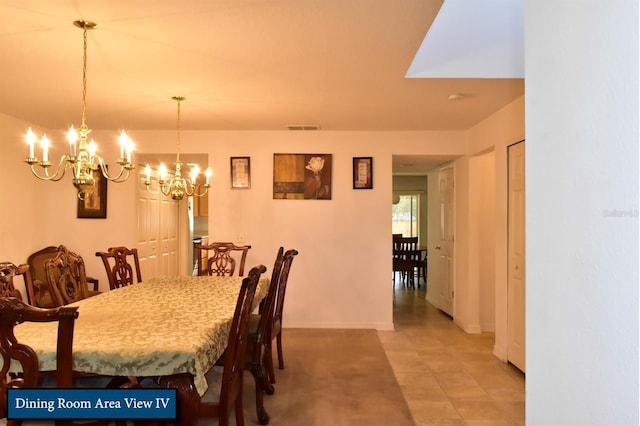 dining area with light tile patterned floors, baseboards, a chandelier, and visible vents