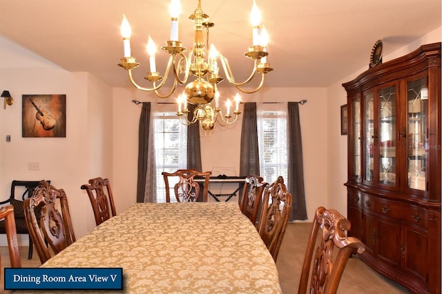carpeted dining room with an inviting chandelier
