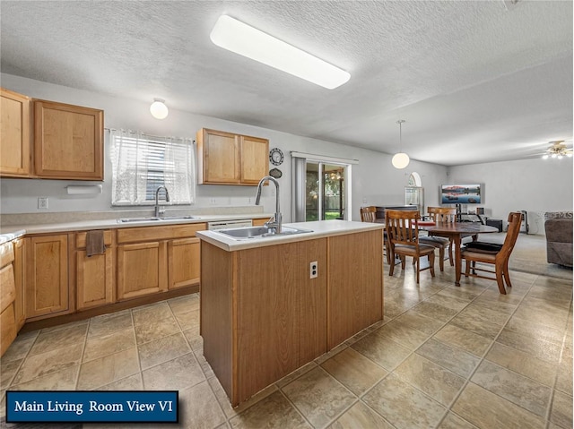 kitchen with light countertops, a sink, and a wealth of natural light