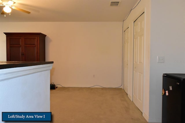 interior space featuring visible vents and light carpet