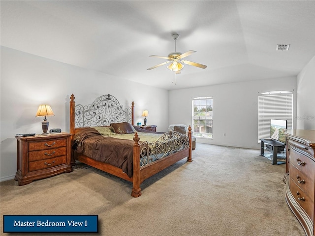 bedroom featuring light colored carpet, visible vents, and ceiling fan