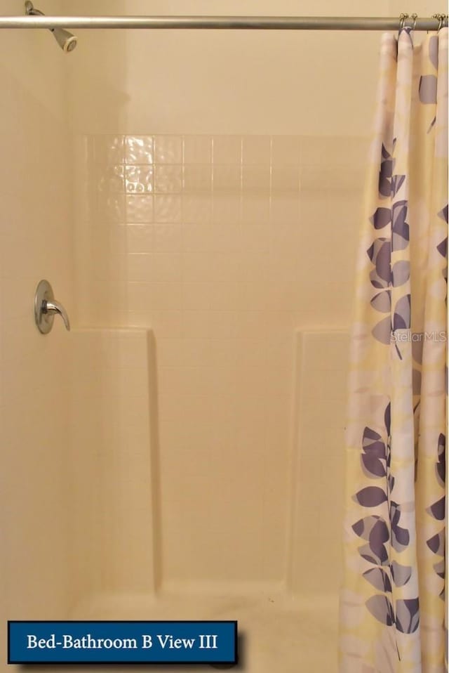 bathroom with a shower with shower curtain