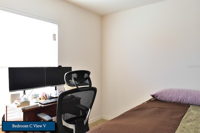 bedroom with carpet floors and baseboards