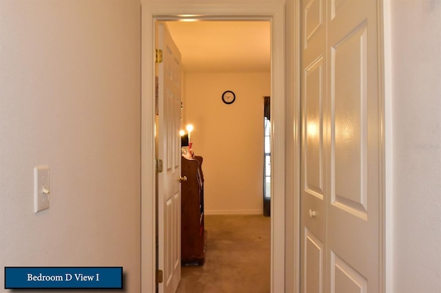 corridor with carpet floors and baseboards