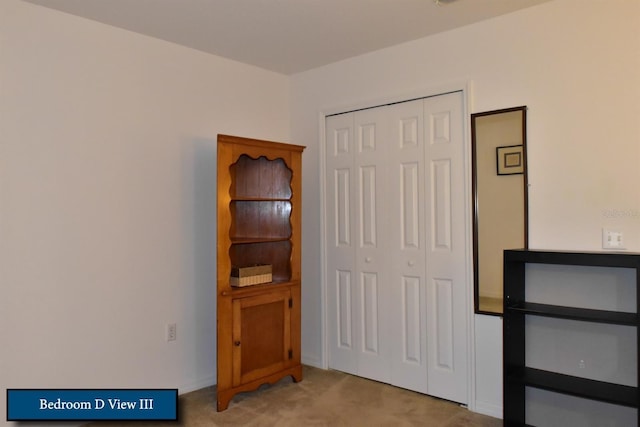 bedroom with light colored carpet and a closet