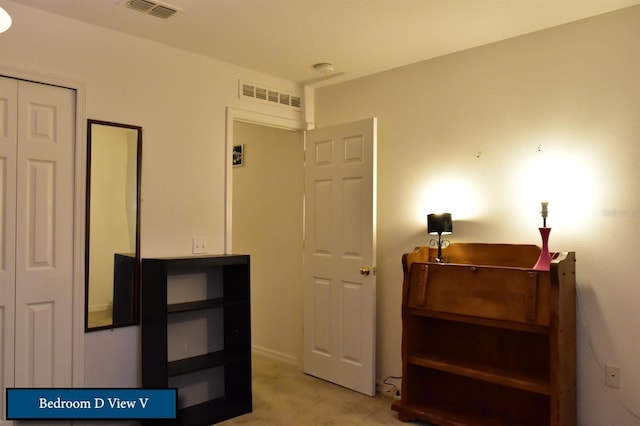 bedroom with visible vents and carpet