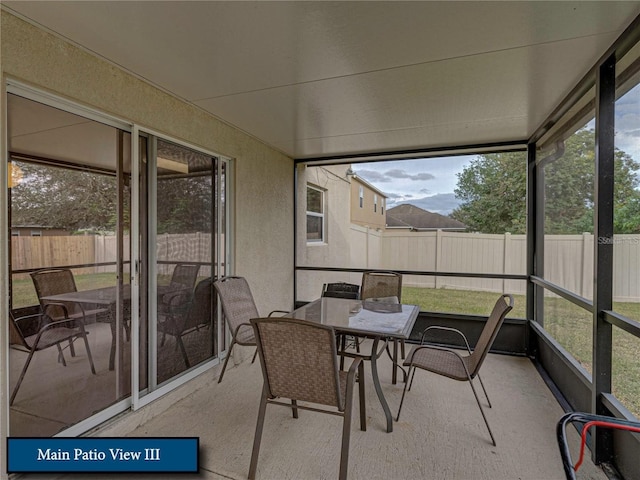 sunroom featuring outdoor dining space