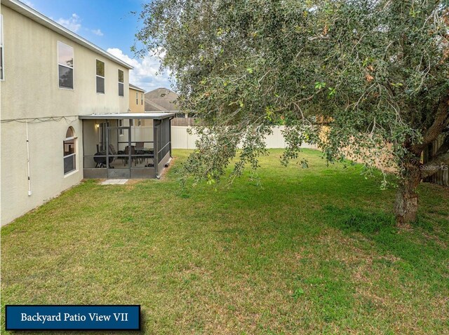 view of yard with a fenced backyard and a sunroom