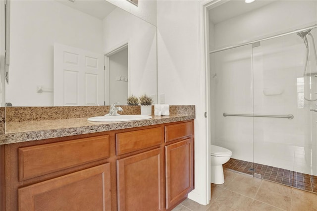 bathroom featuring vanity, tile patterned floors, toilet, and a shower with door