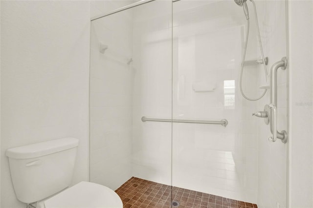 bathroom with an enclosed shower and toilet