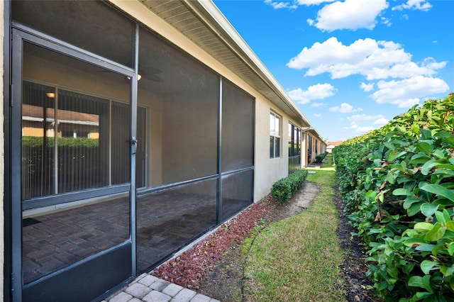 view of side of home with a sunroom