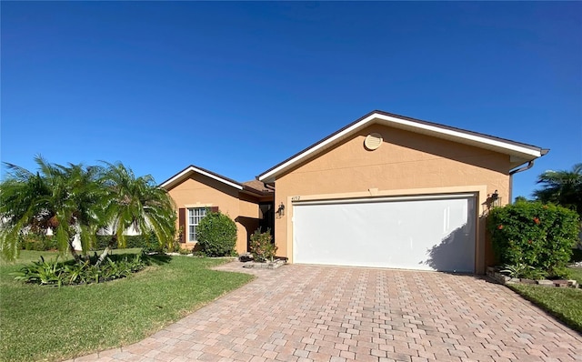 ranch-style home with a garage and a front yard