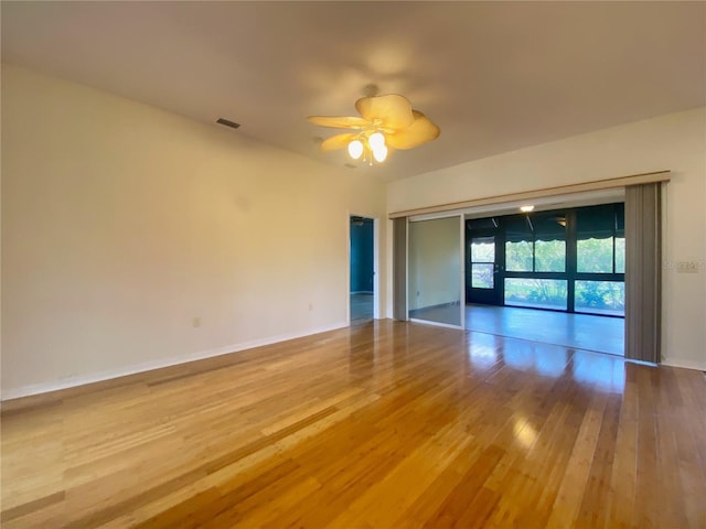 unfurnished room with ceiling fan and light hardwood / wood-style floors