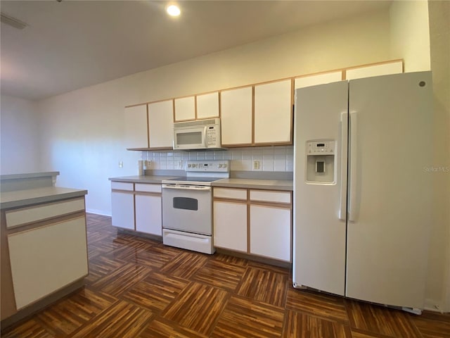 kitchen featuring white cabinets, white appliances, dark parquet floors, and backsplash