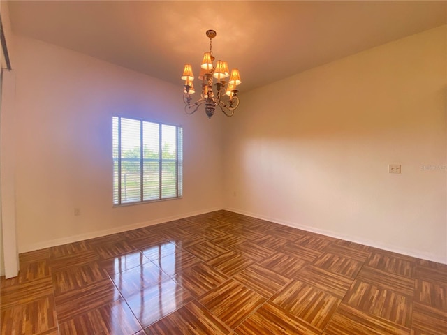 spare room featuring a notable chandelier