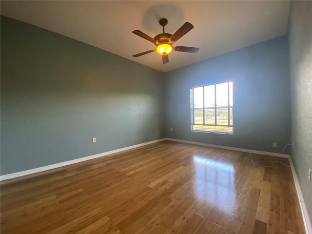 empty room with wood-type flooring and ceiling fan