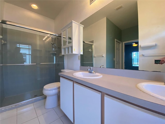 bathroom featuring tile patterned floors, vanity, toilet, and an enclosed shower