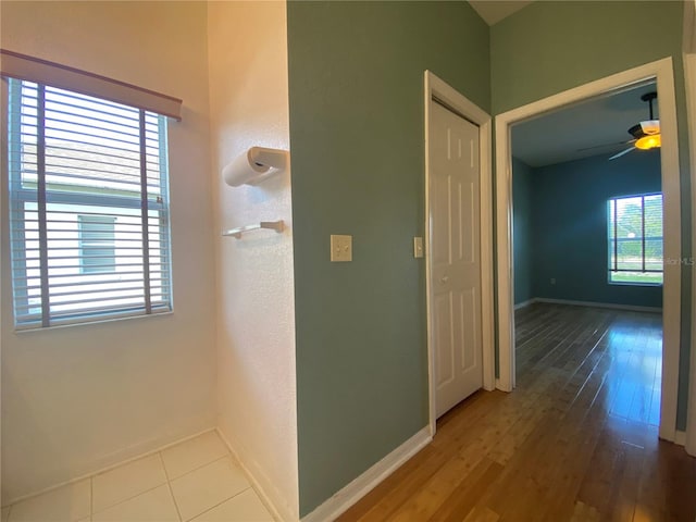 corridor with hardwood / wood-style flooring