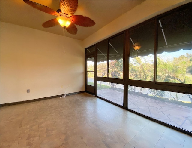 unfurnished room with a wealth of natural light and ceiling fan