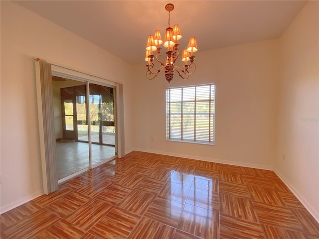 unfurnished room with a chandelier