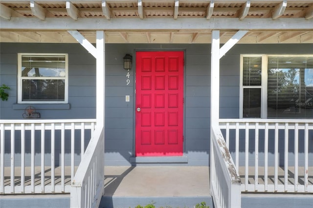 view of exterior entry with covered porch