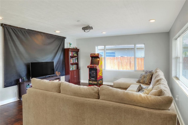 living room with a textured ceiling and dark wood-type flooring