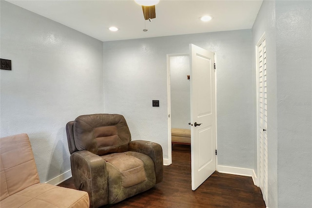 living area with wood finished floors, a textured wall, baseboards, ceiling fan, and recessed lighting