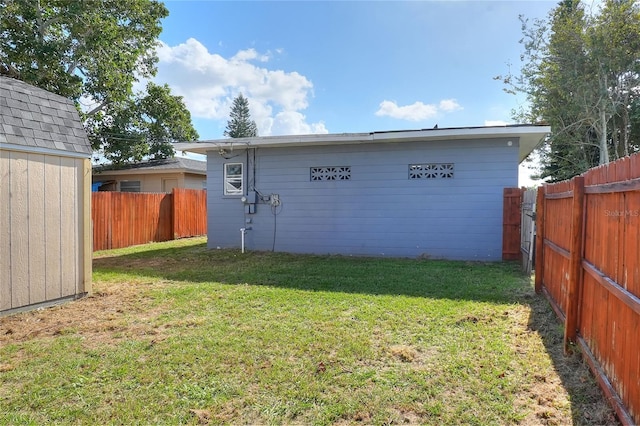 exterior space with a storage shed and a lawn