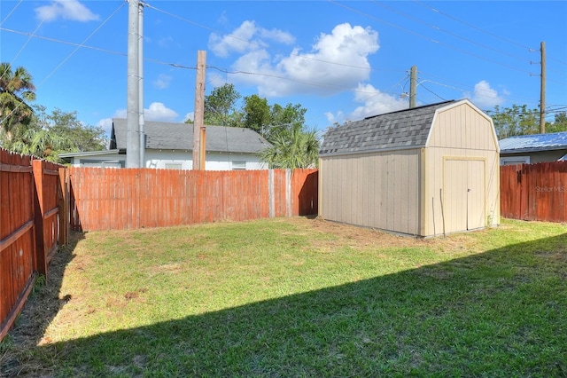 view of yard featuring a storage shed and an outdoor structure