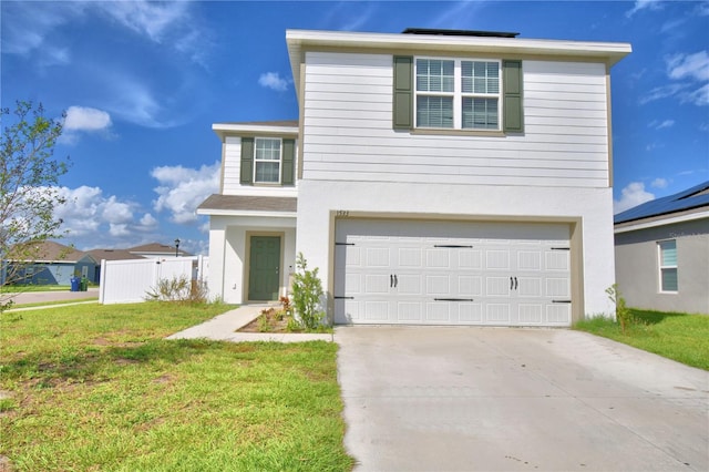 front of property featuring a front lawn and a garage