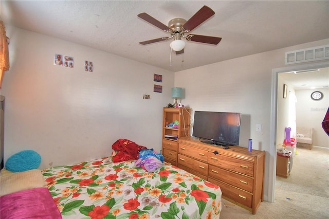 bedroom featuring ceiling fan and light colored carpet