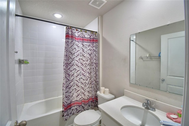 full bathroom featuring vanity, a textured ceiling, toilet, and shower / bathtub combination with curtain