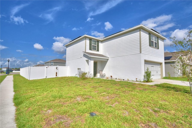 view of front of house featuring a garage and a front lawn