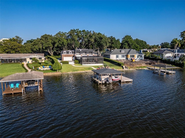 dock area with a water view and a yard