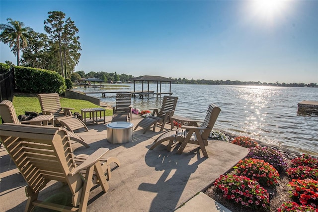 view of patio / terrace featuring a water view and a dock