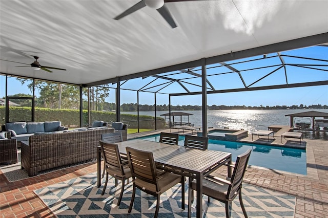 view of patio / terrace with a water view, an outdoor hangout area, a pool with hot tub, ceiling fan, and a lanai