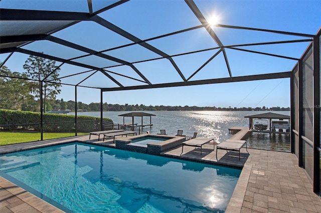 view of pool with an in ground hot tub, a water view, glass enclosure, and a patio area