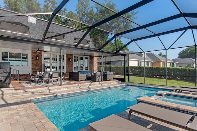 view of swimming pool featuring outdoor lounge area, ceiling fan, a lanai, an in ground hot tub, and a patio area